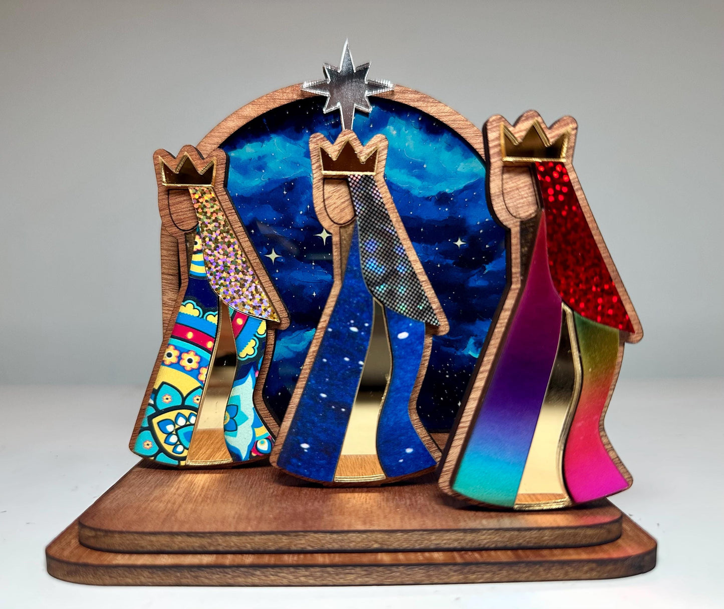 Mahogany kings with colorful robes in front of a night sky, tres Reyes shelf sitter
