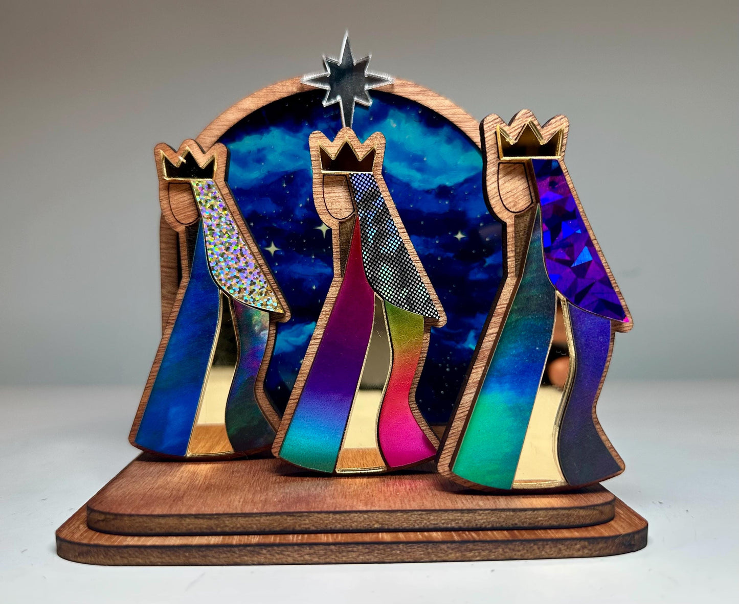 Mahogany kings with colorful robes in front of a night sky, tres Reyes shelf sitter
