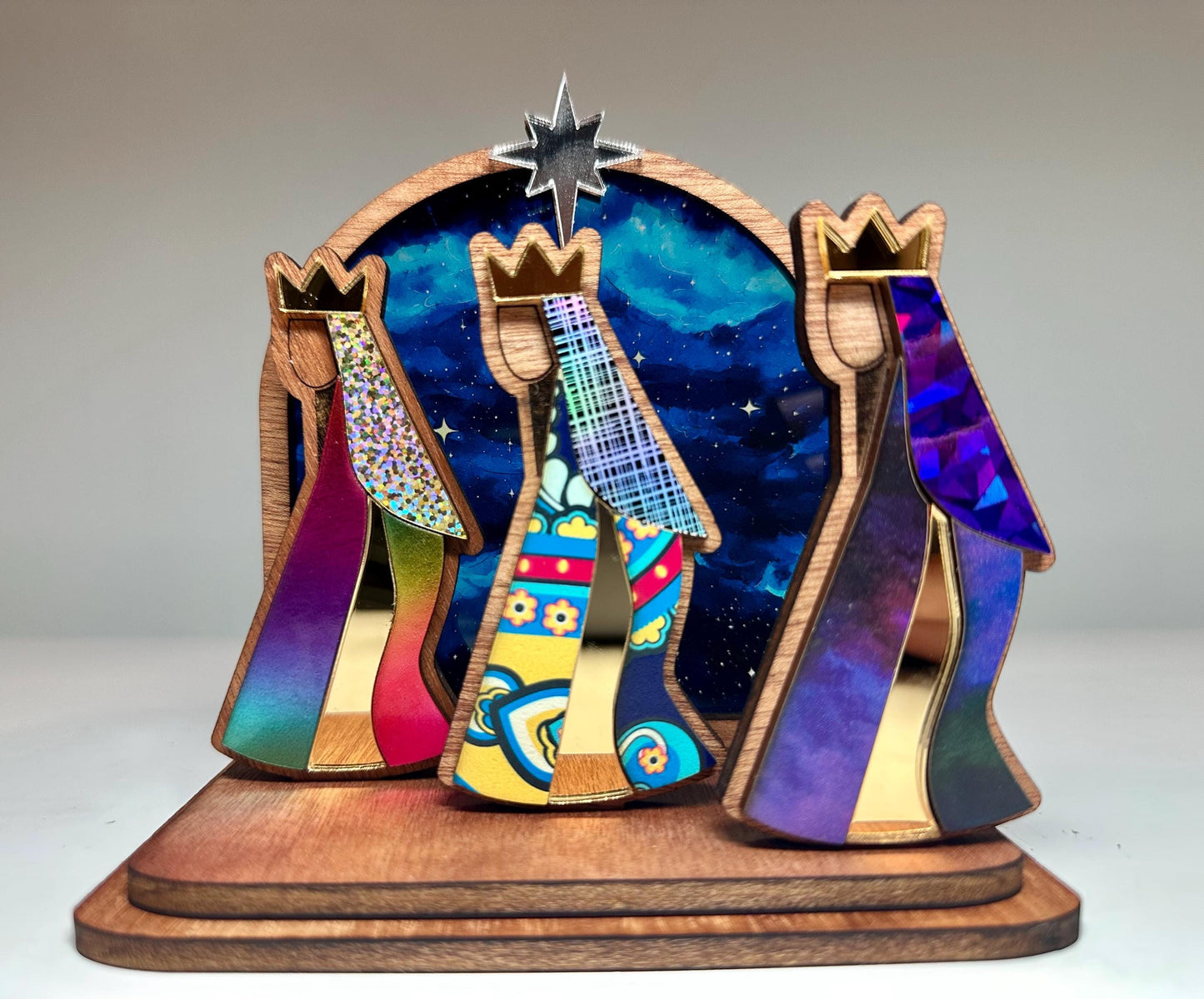 Mahogany kings with colorful robes in front of a night sky, tres Reyes shelf sitter