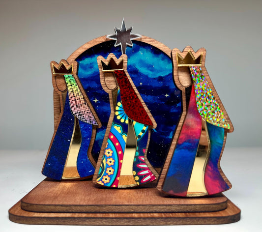 Mahogany kings with colorful robes in front of a night sky, tres Reyes shelf sitter